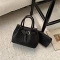 Detail of black matte leather bucket bag set with white contrast stitching and metal buckle - Ebony without Pendant