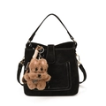 Black matte bucket bag with contrast stitching and a plush puppy charm accessory - With Pendant / Black