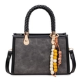 Grey embossed crossbody bag with black braided handles and colorful beaded tassel charm - With Pendant / Black