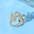 Macro view of gold snake ring with emerald eyes and crystal pavé details - Entwined Spirit Snake Green Pear Drill Eyes Style (JZ0132)