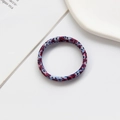 Detail of red and blue patterned fabric hair tie with soft texture on white background - Nylon - Color