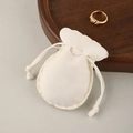 Creamy white velvet jewelry pouch with scalloped edges and drawstring closure - Off-white