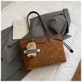 Detailed texture of brown suede tote bag featuring contrast stitching and cute teddy charm - With Pendant / Brown