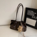 Dark brown suede tote bag with plush puppy charm and tassel detail on white desk - With Pendant / Coffee