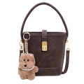 Brown leather bucket bag with top handle, gold clasp, and cute plush dog charm detail - With Pendant / Coffee