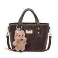 Dark brown matte crossbody bucket bag with golden brand plaque and plush dog charm - With Pendant / Coffee