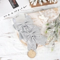Close-up of two sparkling silver glitter Christmas bows with festive snow and pine backdrop - Silver No. 6 Glitter Bow