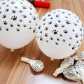 White latex balloons with black paw prints and red pump on wooden surface decoration - 100pcs Pack / White (Black Print)