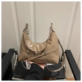 Detail of glossy beige hobo bag with silver buckle and sleek adjustable shoulder strap - Khaki