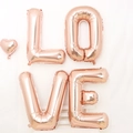 Rose gold LOVE letter foil balloons set with heart on white wooden stool - 32 Rose Gold LOVE Letter Set