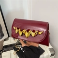 Deep burgundy patent leather crossbody bag with striking wavy gold metal accent - Dark Red