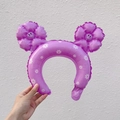 Detail of purple inflatable headband with daisy patterns and smiling flower ear design - Macaron Purple