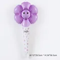 Handheld purple flower daisy balloon with a black smiley face and floral smile handle - Macaron Purple Daisy Inflatable Wand