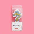 Sparkling gold number 7 birthday candle with blue trim and crown on pink background - Number 7 (4409458047957)