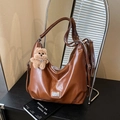 Caramel brown leather hobo bag with plush bear charm and metallic logo detail - With Pendant / Brown