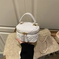 Chic white quilted mini box bag with gold chain strap and top handle in hand - White