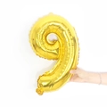 Golden 16-inch number 9 foil balloon held by hand for party decoration size reference - 16" / Shiny Gold Number 9