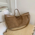 Brown faux suede tote bag with leather straps on a wooden table in a minimalist interior - Khaki