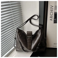 Detail of deep brown retro tote bag with matte leather finish and metal buckle strap - Coffee