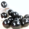 Glossy black latex balloons for party decoration on a white plush background - Black