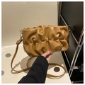 Detail of ochre ruched cloud bag with soft pleated texture and silver hardware accents - Brown