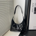 Glossy black patent leather hobo bag with silver buckle and minimalist half-moon shape - Black