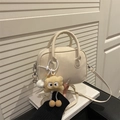 Elegant cream PU leather shoulder bag with plush pendant on a decorative background - With Pendant / White