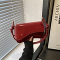 Deep red patent leather underarm bag with knot strap detail and golden hardware - Red