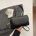 Classic black faux leather crossbody bag with curved flap and gold metal hardware - Black