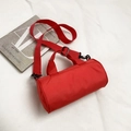 Minimalist red cylindrical travel bag with top handles and adjustable shoulder strap - Red