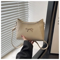 Chic beige faux leather shoulder bag with a stylish gold bow metal buckle detail - Khaki