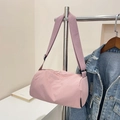 Light pink cylindrical nylon crossbody bag with adjustable wide fabric shoulder strap - Pink