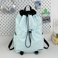 Light mint green drawstring backpack with black straps and multi-pocket design - Light Blue