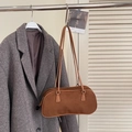 Brown faux suede oversized underarm hobo bag hanging over a grey tweed wool coat - Brown