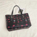 Minimalist black tote bag with colorful lip prints and gold rivet details for women - Black