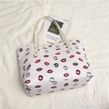 White printed tote bag with red lip patterns and gold rivet hardware on white fabric - Off White