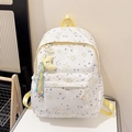 Detail of white backpack with purple and yellow stars, side pocket and moon plush charm - Yellow