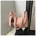 Detail of pink suede shoulder bag featuring decorative black and white woven fringe tassels - With Pendant / Pink