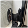 Detail of minimalist black hobo bag showing woven cord charm and matte texture - With Pendant / Black