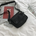 Black canvas crossbody messenger bag with multi-pocket design and adjustable strap - Black
