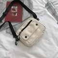 Minimalist cream canvas crossbody bag with black adjustable strap for casual daily use - White