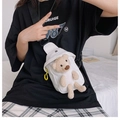 Detail of white canvas chest bag featuring a plush 3D bear and durable black strap - White