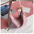 Detail of dusty pink crescent bag with nylon texture, black strap and ball pendant - Pink
