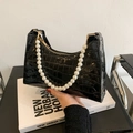 Chic black crocodile embossed dumpling bag with large pearl handle and gold zipper - Black