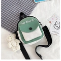 Green and cream canvas crossbody bag with mini bear charm and adjustable strap - Green