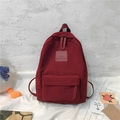 Sac à dos en nylon rouge foncé pour femme avec poche zippée et étiquette en cuir mode - Bordeaux