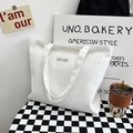 Minimalist white canvas tote bag with letter patch on black and white checkered base - White
