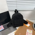 Detail of black corduroy mini backpack texture on office desk with MacBook - Black
