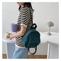 Mini corduroy backpack in dark green featuring adjustable straps and front pocket - Green