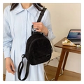 Chic black corduroy mini backpack for women, shown in a stylish crossbody carry style - Black